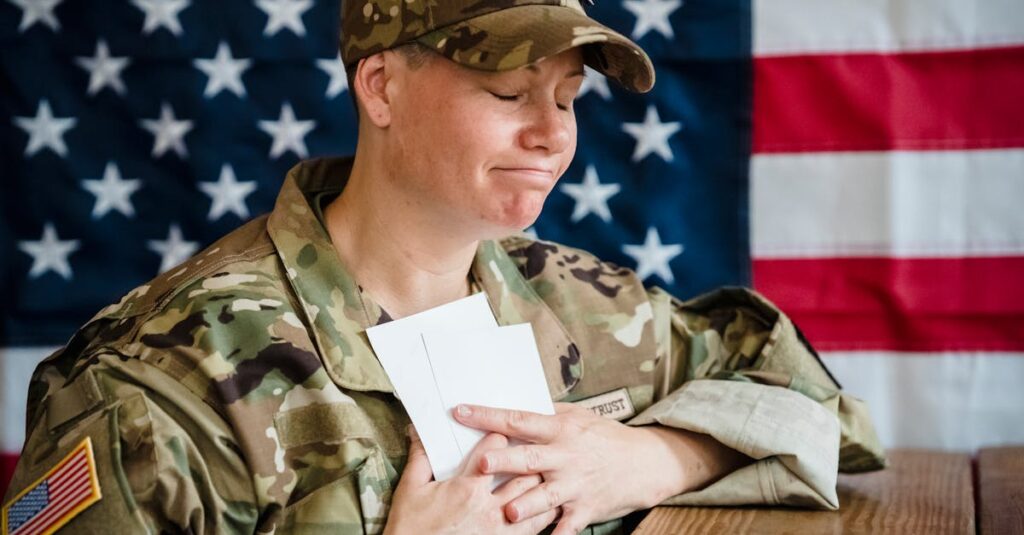 A soldier in uniform holds envelopes emotionally in front of an American flag background.